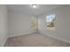 Bright bedroom with carpet flooring and two windows at 804 Pryor St # 49, Mebane, NC 27302