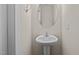 Modern pedestal sink and oval mirror in a small bathroom at 806 Pryor St # 50, Mebane, NC 27302