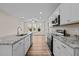 Modern kitchen with white cabinets, granite countertops, and stainless steel appliances at 806 Pryor St # 50, Mebane, NC 27302