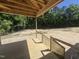 Newly constructed wooden deck offering a view of the spacious backyard surrounded by mature trees at 236 Alden Way, Angier, NC 27501