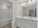 Bright bathroom features double sinks, white cabinets, large mirror, and a tub/shower combination at 236 Alden Way, Angier, NC 27501