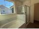 Bathroom with a tub and separate glass enclosed shower at 236 Alden Way, Angier, NC 27501
