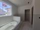 Unfinished bathroom with a bathtub, window, and doorway to another space at 236 Alden Way, Angier, NC 27501