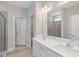 Bright bathroom with double sinks, white cabinets, large mirror, and a walk-in shower at 236 Alden Way, Angier, NC 27501