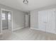 Spacious bedroom featuring neutral carpeting, white trim, multiple closets, and an open doorway at 236 Alden Way, Angier, NC 27501