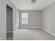 Neutral bedroom featuring neutral carpeting, white trim, one window and a walk-in closet at 236 Alden Way, Angier, NC 27501