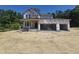 New construction featuring a two-story home with an attached three-car garage, showcasing modern design elements and future curb appeal at 236 Alden Way, Angier, NC 27501