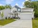 Charming two-story home with white siding, blue accents, stone details, and a two-car garage at 236 Alden Way, Angier, NC 27501