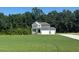 Charming home with attached two-car garage, welcoming front lawn, and mature trees providing privacy at 236 Alden Way, Angier, NC 27501