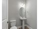 Stylish half bathroom with a pedestal sink, modern toilet, and neutral paint at 236 Alden Way, Angier, NC 27501