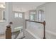 Bright hallway features hardwood railing, white trim, neutral walls and an open view of the home at 236 Alden Way, Angier, NC 27501