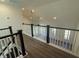Upstairs hallway showcasing dark wood and white banisters, and vaulted ceiling with recessed lights at 236 Alden Way, Angier, NC 27501