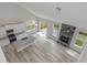 Bright, open kitchen with granite countertops, white cabinets, stainless appliances, and a gray stone fireplace at 236 Alden Way, Angier, NC 27501