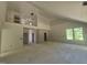 Unfinished living room with a loft area, tall ceilings, and large windows for ample natural light at 236 Alden Way, Angier, NC 27501