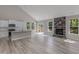 Open-concept living room features a stone fireplace, vaulted ceiling, and access to a modern kitchen at 236 Alden Way, Angier, NC 27501