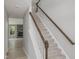 Carpeted staircase with white banister and dark wood railing leading to the upper level of the home at 236 Alden Way, Angier, NC 27501
