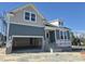 Two-story home under construction with blue siding, white trim, and an attached two-car garage at 291 Alden Way, Angier, NC 27501