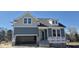 Two-story home under construction with blue siding, white trim, and an attached two-car garage at 291 Alden Way, Angier, NC 27501