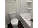Compact bathroom featuring a toilet and a combined tub and shower, perfect for essential needs at 1050 Mountain Crown St, Durham, NC 27703