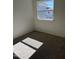 A simple bedroom with carpet, a window, white walls, and electrical outlets, filled with natural light at 1050 Mountain Crown St, Durham, NC 27703