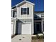 Charming exterior of a two-story home featuring a white garage door, light green siding and black shutters at 1050 Mountain Crown St, Durham, NC 27703
