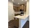Modern kitchen with stainless steel appliances, light brown cabinets, white countertops and a breakfast bar at 1050 Mountain Crown St, Durham, NC 27703