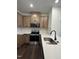Modern kitchen with stainless steel appliances, light brown cabinets and white countertops plus a black faucet at 1050 Mountain Crown St, Durham, NC 27703