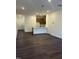 A view of the living room with hardwood floors, recessed lighting, and a kitchen with a breakfast bar at 1050 Mountain Crown St, Durham, NC 27703