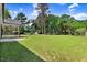 Large backyard features a spacious lawn and mature trees at 6965 Us-401, Fuquay Varina, NC 27526