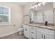 This bathroom features double sinks, granite counters, black fixtures, and a large mirror at 6965 Us-401, Fuquay Varina, NC 27526