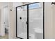Walk-in shower with glass door and built-in bench in bright and modern bathroom at 6965 Us-401, Fuquay Varina, NC 27526