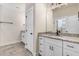 Bright bathroom with double vanity, granite countertop, white cabinets, and tile flooring at 6965 Us-401, Fuquay Varina, NC 27526