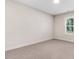 Bedroom with carpeted floor, neutral walls, natural lighting, and view to the outside at 6965 Us-401, Fuquay Varina, NC 27526