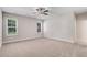 Carpeted bedroom with two windows offering natural light and views of the outside at 6965 Us-401, Fuquay Varina, NC 27526