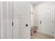 This entryway features a built in bench, coat hooks, and a solid core door at 6965 Us-401, Fuquay Varina, NC 27526