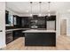Stylish kitchen with black cabinetry, stainless steel appliances, and a large island with pendant lighting at 6965 Us-401, Fuquay Varina, NC 27526