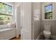 Bright bathroom with a window seat and patterned tile, offering a cozy and stylish space at 1015 Minerva Ave, Durham, NC 27701