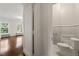 Convenient half-bathroom featuring classic fixtures, next to a room with gleaming hardwood floors at 1015 Minerva Ave, Durham, NC 27701