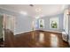 Light-filled bedroom with refinished wood floors, light blue walls, and traditional-style radiators at 1015 Minerva Ave, Durham, NC 27701