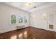 Bright bedroom boasts arched windows, original hardwood floors, and fresh white walls at 1015 Minerva Ave, Durham, NC 27701