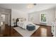 Bright bedroom featuring hardwood floors, natural light, and neutral decor at 1015 Minerva Ave, Durham, NC 27701