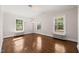 Sunny bedroom featuring refinished wood floors, fresh white paint and classic trim at 1015 Minerva Ave, Durham, NC 27701