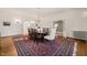 Formal dining room featuring hardwood floors, bright windows, and a decorative chandelier at 1015 Minerva Ave, Durham, NC 27701