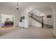 Bright foyer featuring elegant staircase, chandelier, and open view into the dining room at 1015 Minerva Ave, Durham, NC 27701