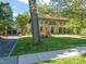 Beautiful brick home with lush green lawn and mature trees providing shade and curb appeal at 1015 Minerva Ave, Durham, NC 27701