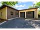 Two-car garage featuring dark doors and parking space with a paved driveway at 1015 Minerva Ave, Durham, NC 27701