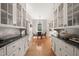 Bright kitchen featuring hardwood floors, marble countertops, and custom cabinetry at 1015 Minerva Ave, Durham, NC 27701