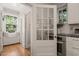 Bright kitchen features a window seat, stainless oven, and white door leading to another space in the home at 1015 Minerva Ave, Durham, NC 27701
