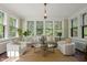 Light-filled sunroom with a sitting area, large windows, and a beautiful view at 1015 Minerva Ave, Durham, NC 27701