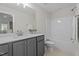 Modern bathroom with gray vanity, white countertops, and bathtub with showerhead at 15 Diamond Creek Dr, Zebulon, NC 27597